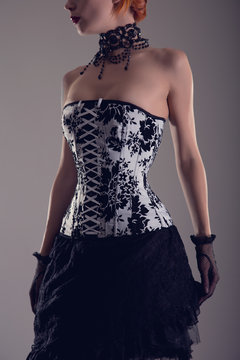 Beautiful young woman in black and white corset