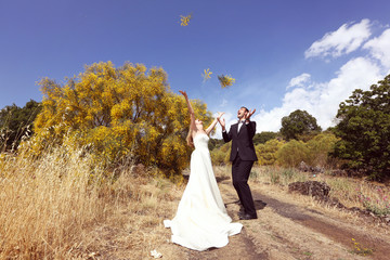 Bride and Groom having fun in the fields