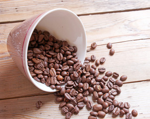 Cup and beans on a wooden table