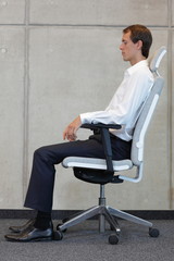 business man on chair in correct sitting position - resting