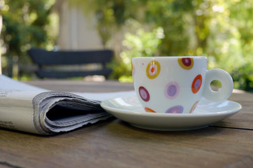 colorful espresso cup and newspaper
