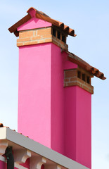 Fuchsia chimneys of houses of Burano island in Italy