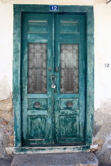 Distressed green flaking painted doors	