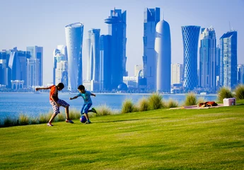 Fotobehang Boys playing football in Doha qatar © kubikactive