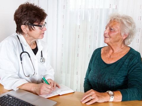 Doctor talking with elderly woman