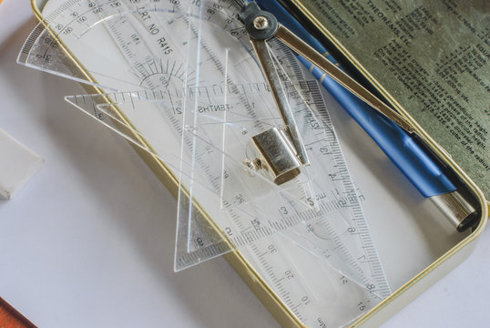 Compasses, pencil and rulers on squared paper