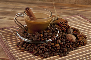 Cup of coffee, grains, and spices against the canvas