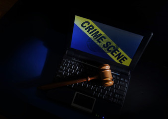 Gavel on laptop crime scene