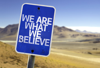 We Are What We Believe sign with a desert background - obrazy, fototapety, plakaty