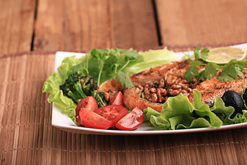 grilled salmon with salad and nuts