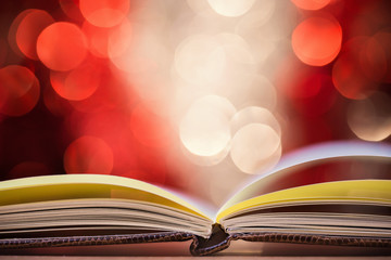 Close up of open book against defocused lights background