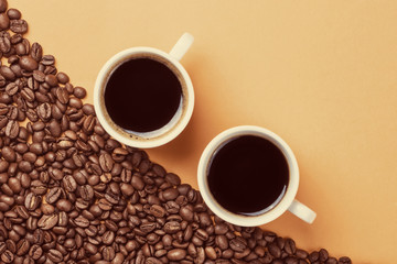Two cups of coffee on coffee beans background, instagram style t