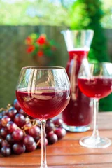 Fotobehang Two glasses of delicious homemade red wine with grape. © AnnaElizabeth