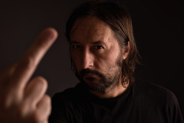 Aggressive man giving middle finger