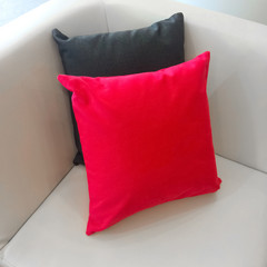 Sofa corner with red and gray cushions