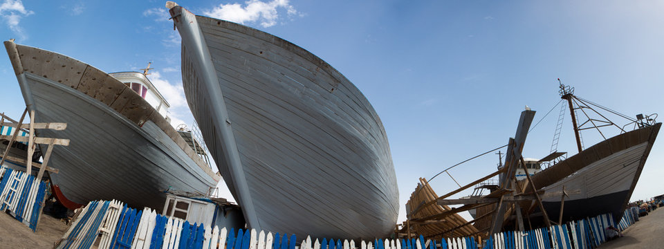 Wooden fishing boats under construction in shipyard, Morocco
