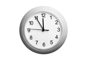 A single simple clock showing the time five to twelve
