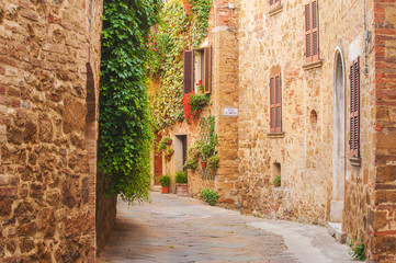 Fototapeta na wymiar Twisted medieval streets with colorful flowers and green plants