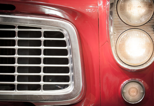 Close Up of Grille and Headlights of Red Vehicle
