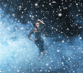 Fototapeta na wymiar Young and emotional woman in fashion dress on a snowy background