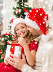 smiling father and daughter holding gift box
