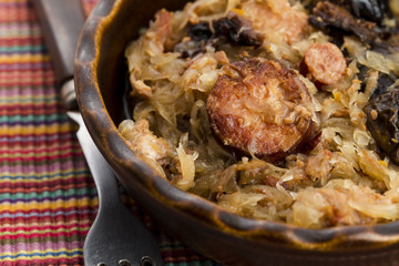 traditional polish sauerkraut (bigos) with mushrooms and plums