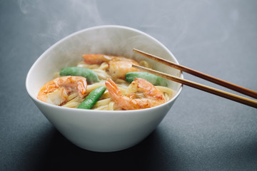 hot noodles with shrimps on a black background