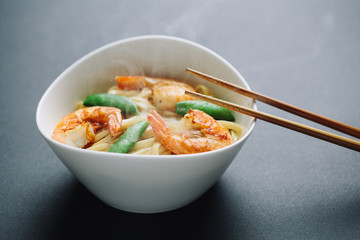 hot noodles with shrimps on a black background