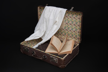 Old Suitcase With Book and Clothes