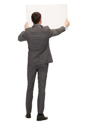 businessman or teacher with white board from back