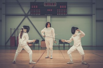 Children fencers and their  trainer