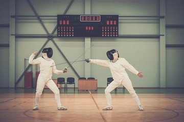 Two women fencers on a training