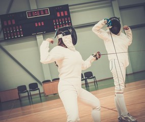 Two women fencers on a training