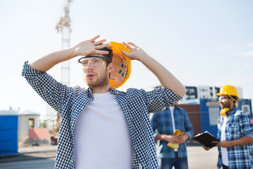 group of builders in hardhats outdoors