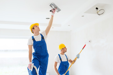 group of builders with tools indoors