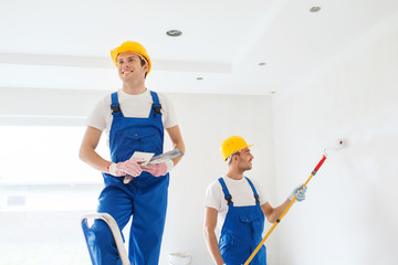 group of builders with tools indoors