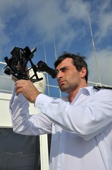 navigator with sextant on the watch on sea going vessel