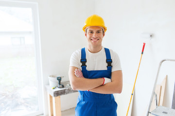 smiling young builder in hardhat  indoors