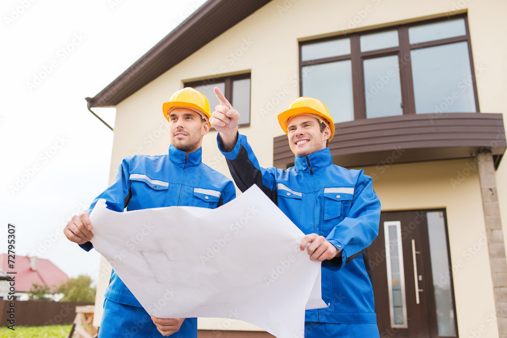 Wall mural group of builders with blueprint pointing finger