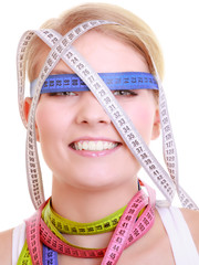 Obsessed fitness woman with a lot of colorful measure tapes