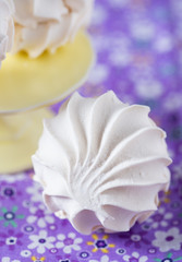 Vanilla marshmallows over purple background