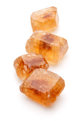 Brown caramelized lump cane sugar cube isolated on white backgro