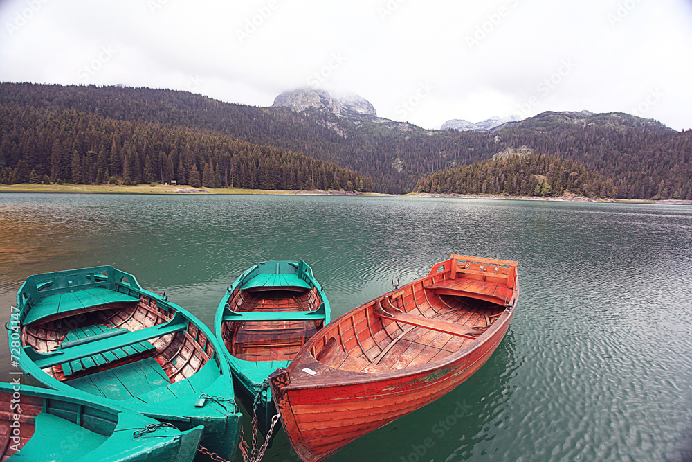 Wall mural wooden boat on a mooring mountain lake