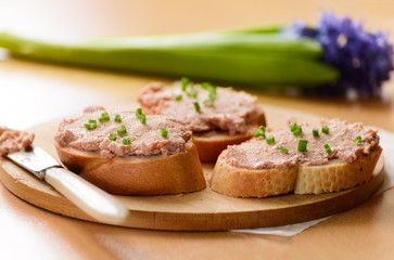 Sandwiches with meat pate. Decorated with green onion rings.