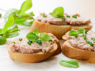 Sandwiches with paste and green onions. Served with mint sprigs.