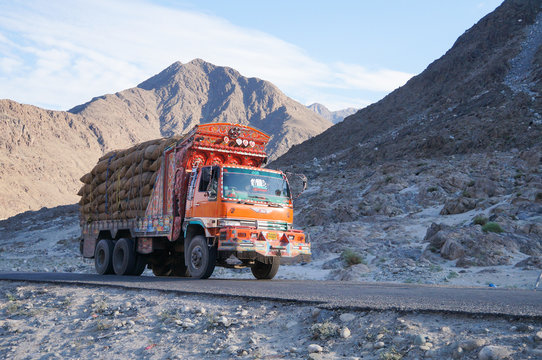Decorative old   truck with Karakoram mountain range in the back