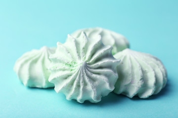Mint color meringues on color background