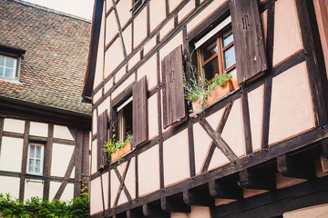 Old half timber (fachwerk) windows on house in Colmar, France.