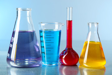Different laboratory glassware with colorful liquid