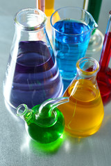 Different laboratory glassware with colorful liquid